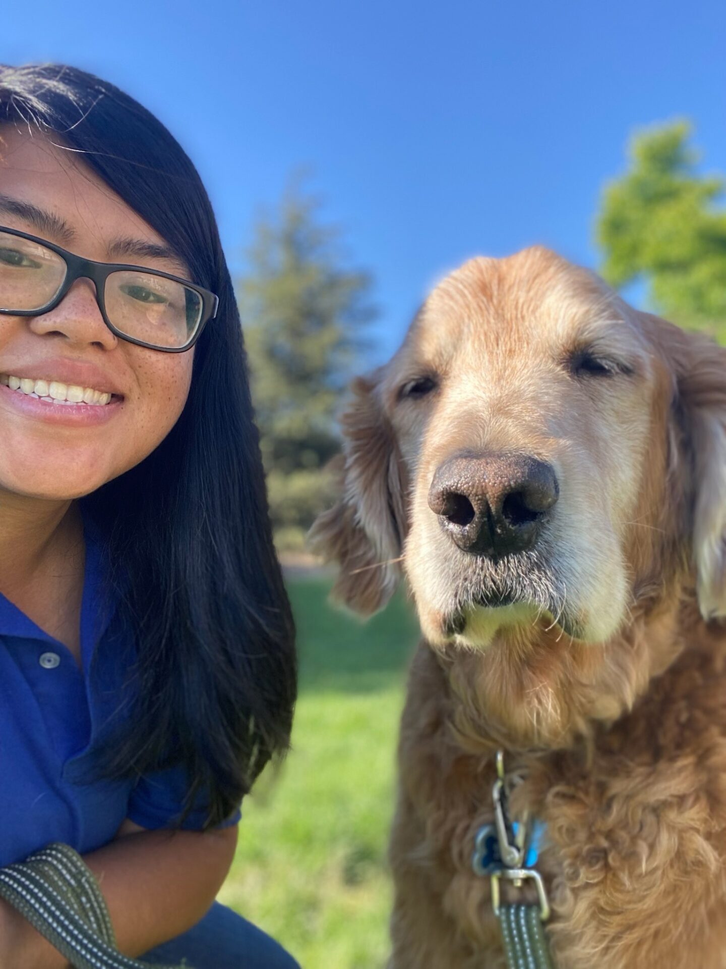 A woman and her dog are smiling for the camera.