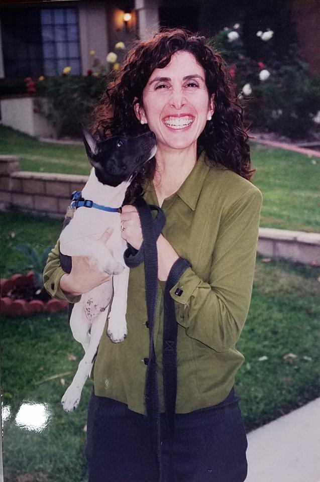 A woman holding a dog in her arms.